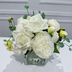 White real touch rose and peony faux floral arrangement in a square glass vase