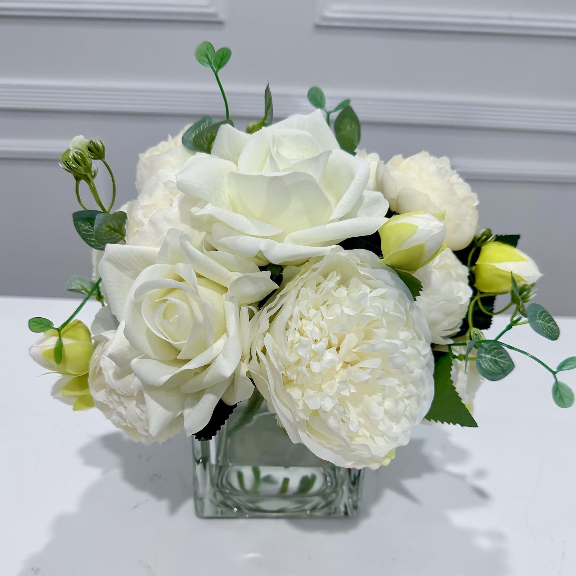 White real touch rose and peony faux floral arrangement in a square glass vase