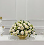 White peony arrangement with green foliage in gold vase