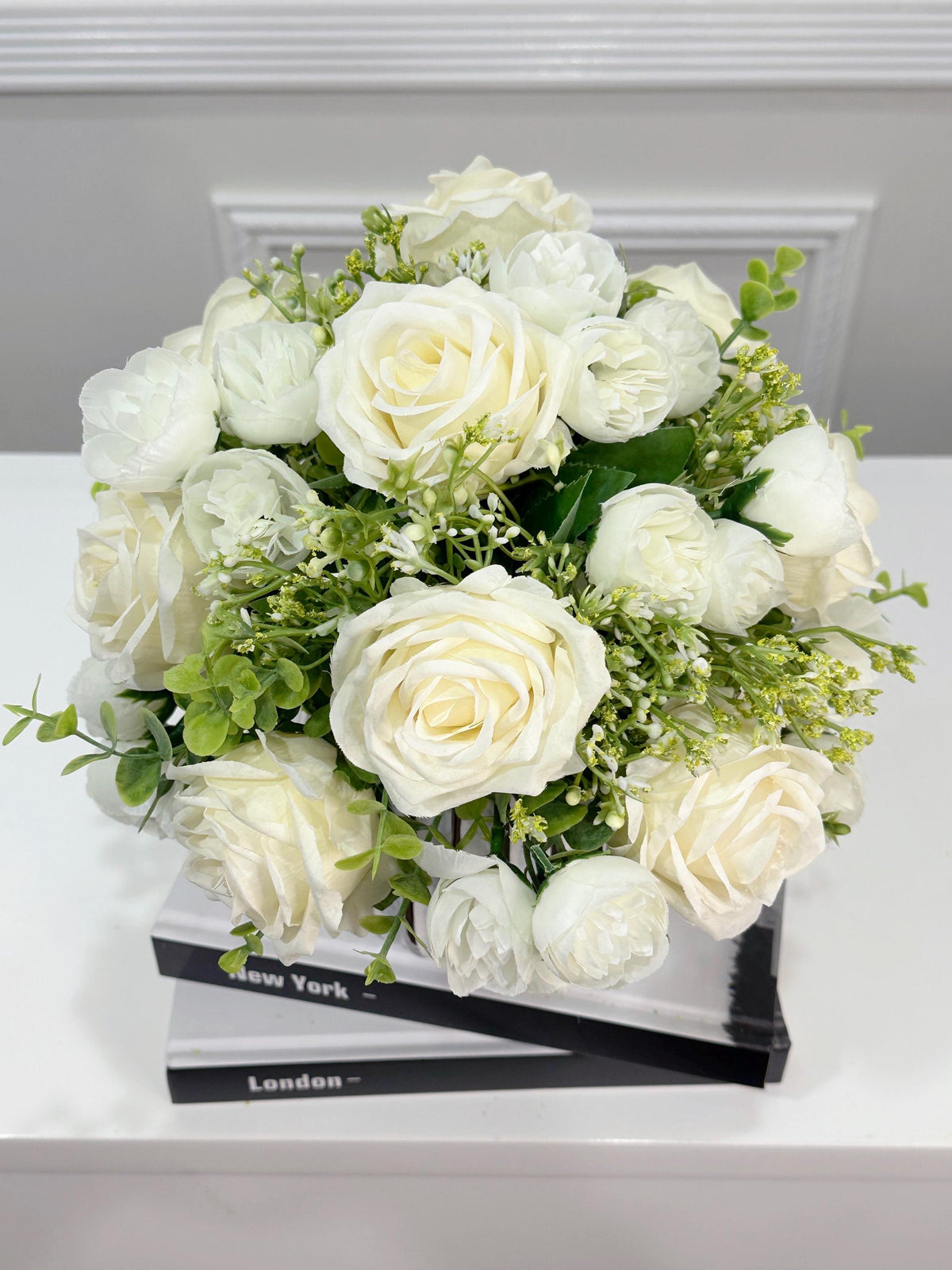 White silk rose and peony faux floral centerpiece in a ribbed vase