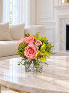 Pink and green real touch rose and orchid faux floral centerpiece in a glass vase