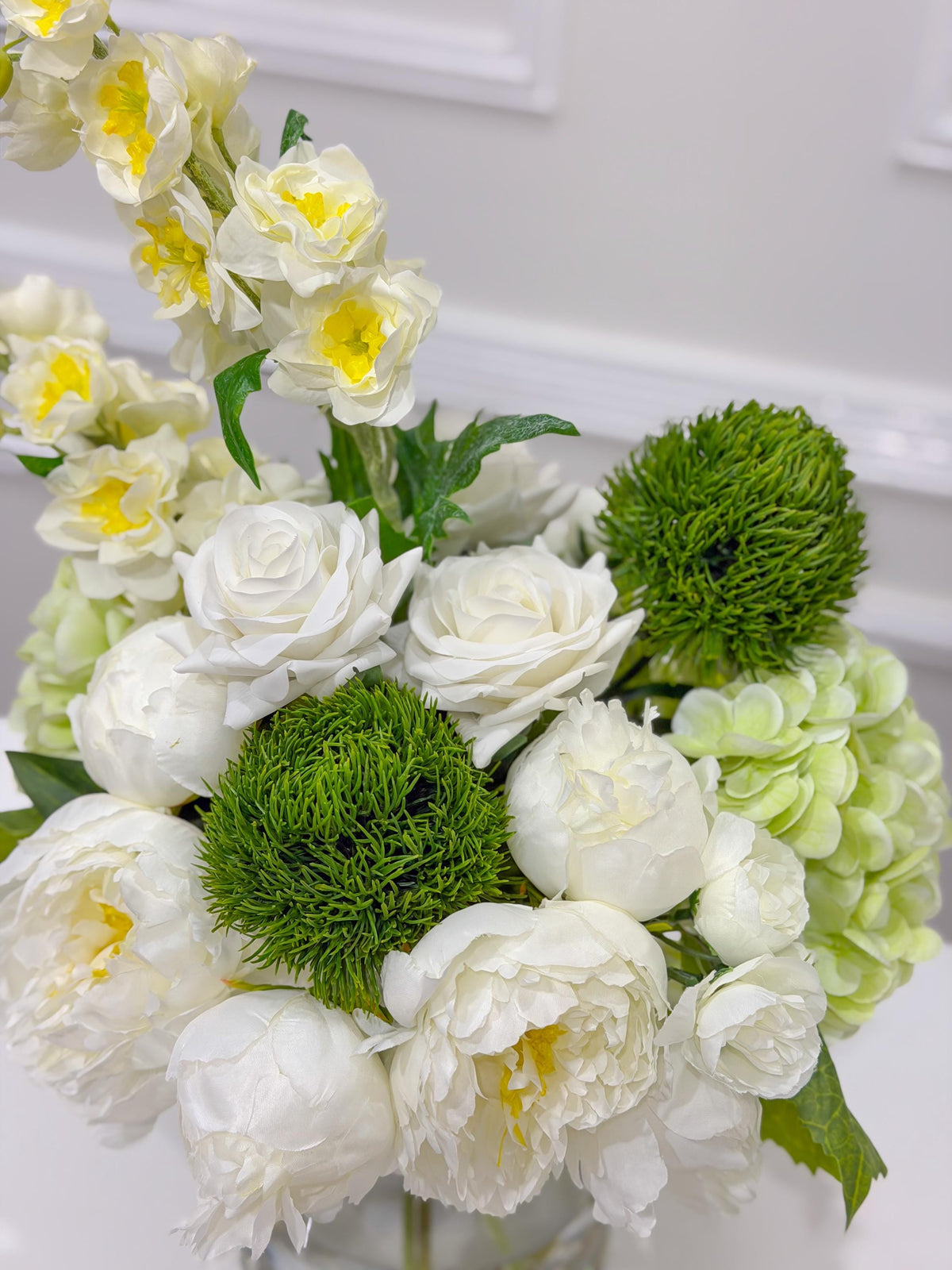 Handcrafted white green centerpiece with clear glass vase and faux water
