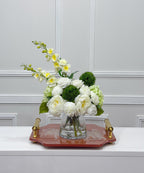 Luxury white and green faux flower centerpiece on a decorative tray