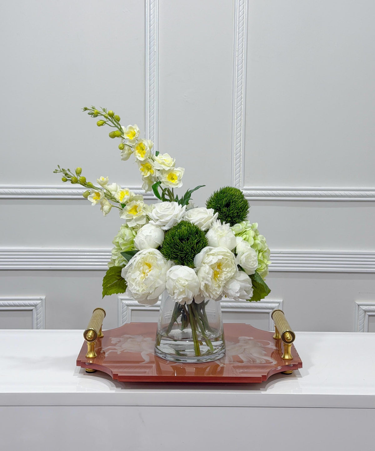 Luxury white and green faux flower centerpiece on a decorative tray