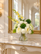 White green real touch hydrangea rose and silk peony centerpiece in a clear glass vase on a marble console