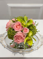 Pink and green real touch rose and orchid faux floral centerpiece in a glass vase