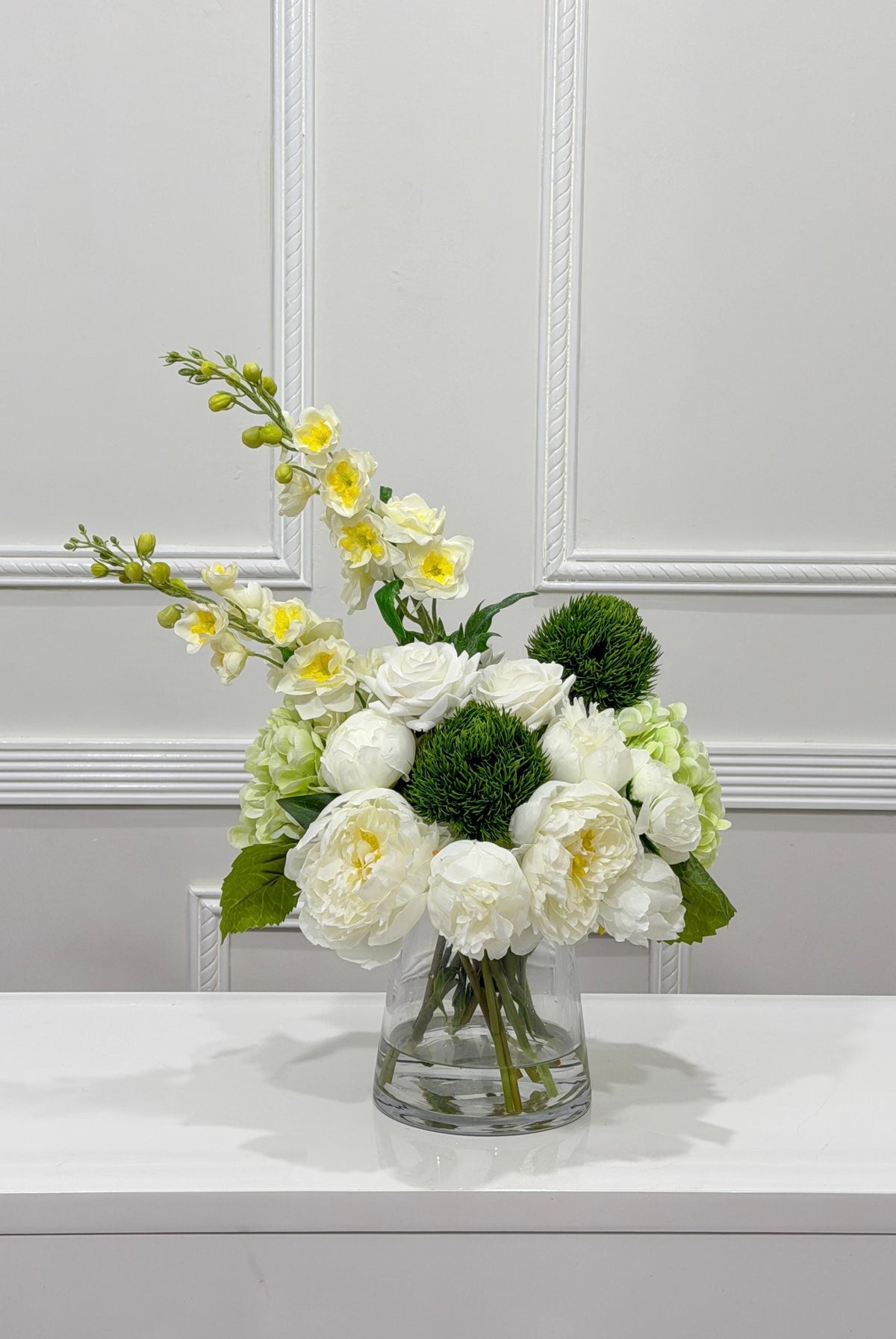 Side view of white peony rose and green hydrangea artificial flower centerpiece