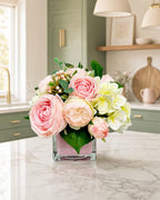 Real touch pink rose and faux hydrangea arrangement in pink cube glass vase on kitchen island