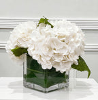 White hydrangea arrangement in glass vase