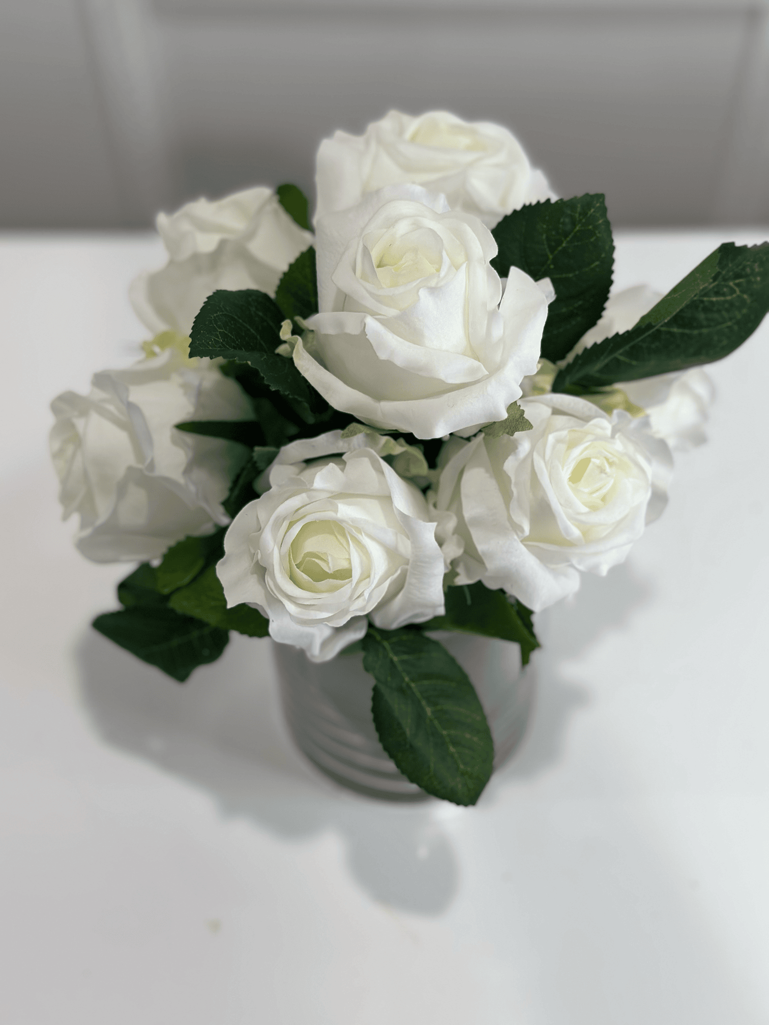 Cream rose bouquet in glass vase