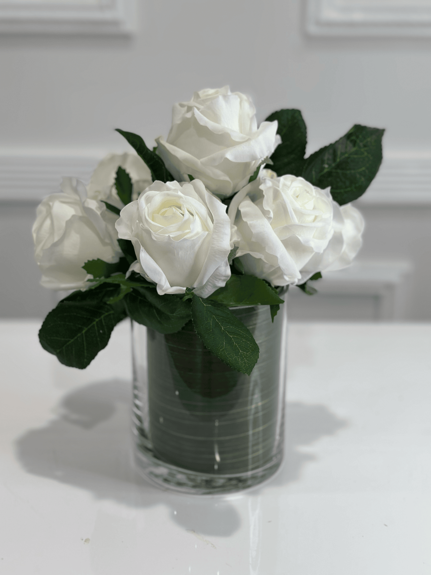 White rose arrangement in glass vase