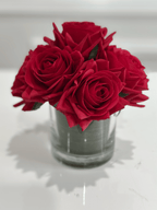 Red rose arrangement in glass vase