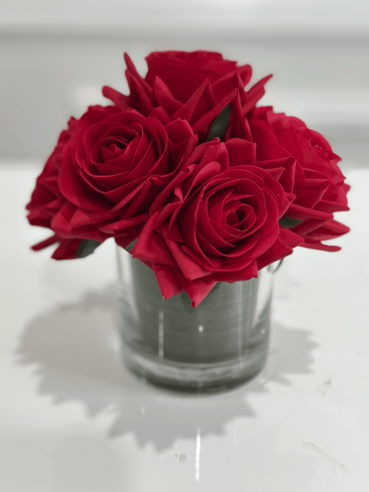 Red rose arrangement in glass vase