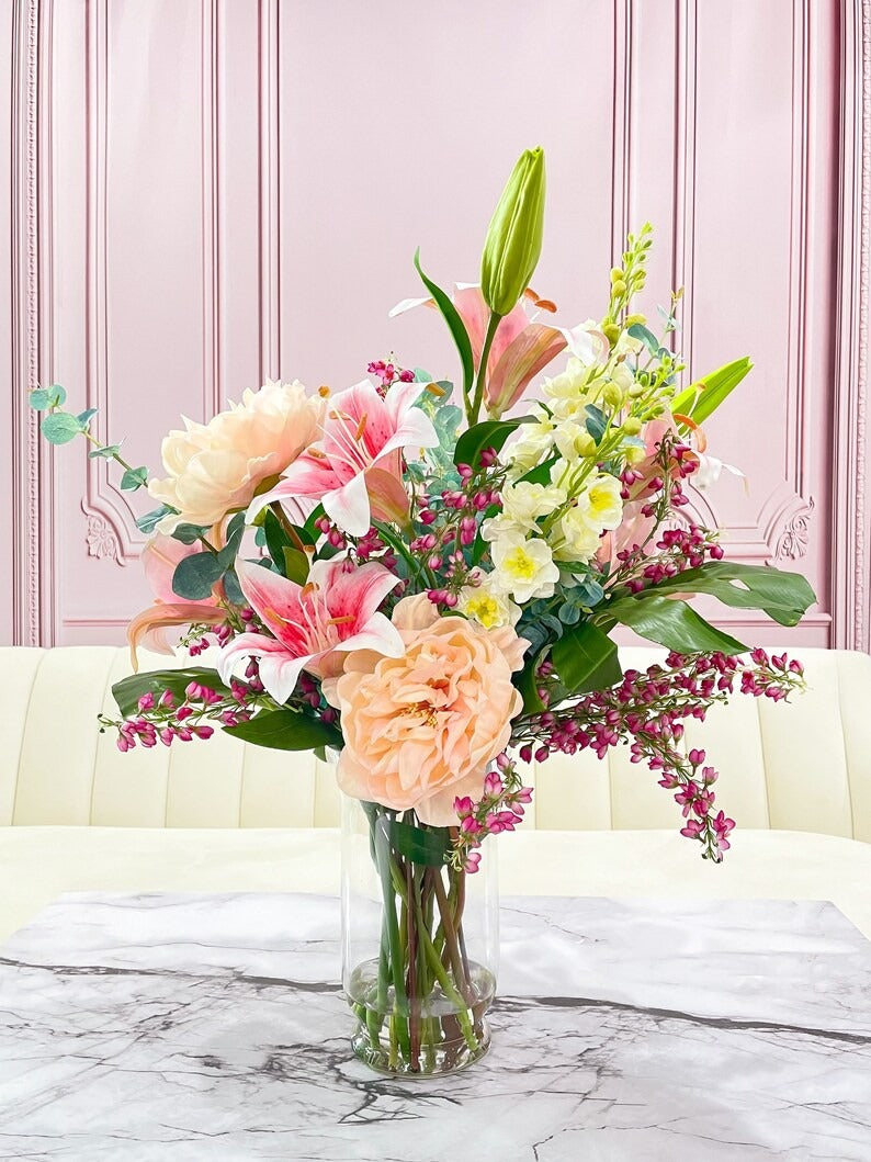 Pink artificial shop flowers in vase